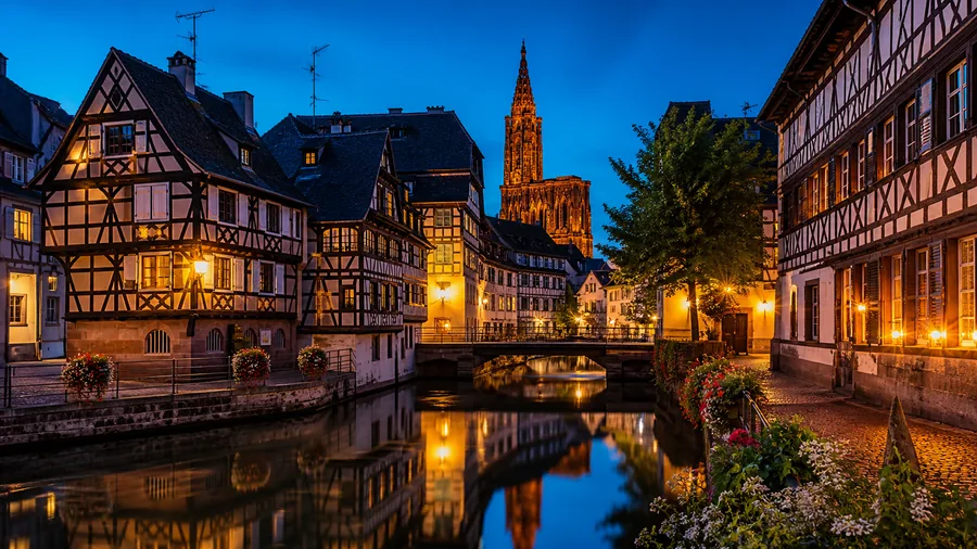 Ambiance romantique inspirée de Strasbourg avec canaux de la Petite France, maisons à colombages et cathédrale illuminée